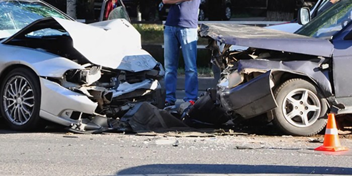 A small car collides head on with a large suv