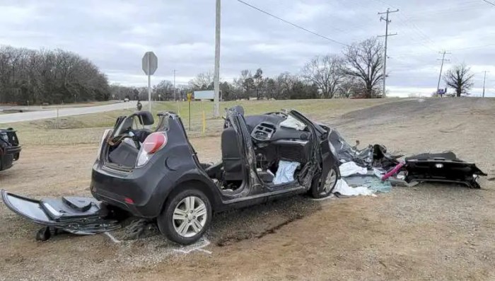 A small car collides head on with a large suv